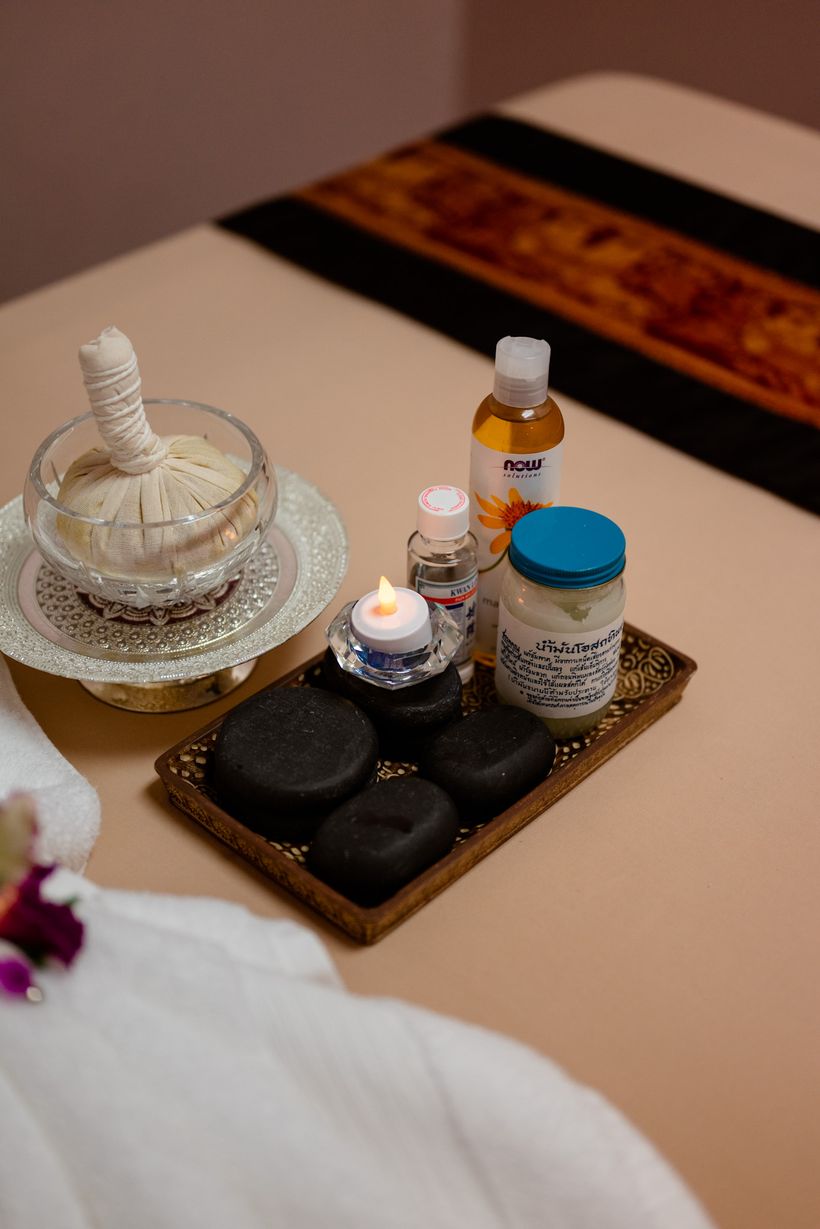 Hot stones, herbal compress and massage oil at Magnolia Wellness Massage