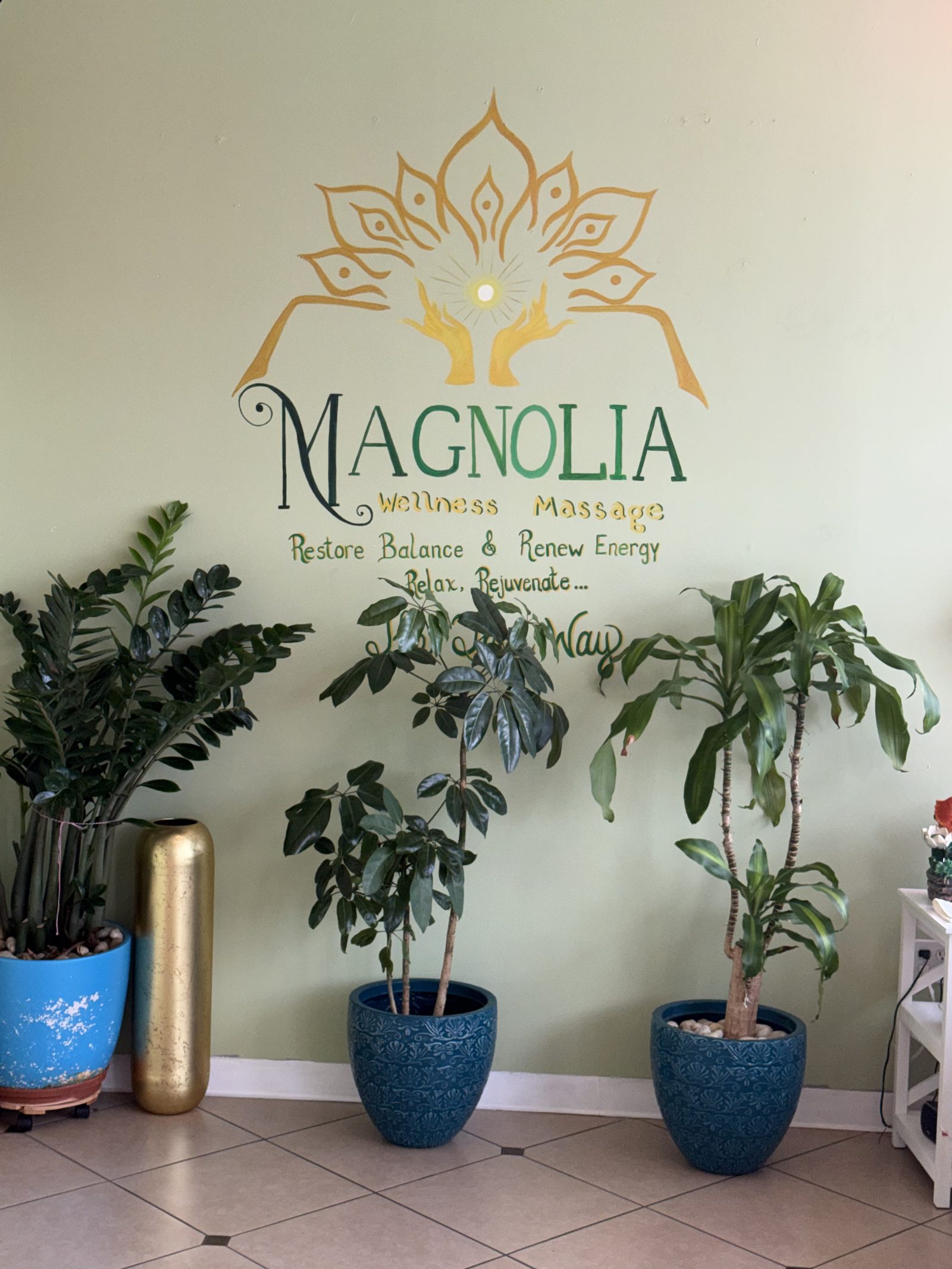 Magnolia Wellness Massage logo on the relaxation-room wall
